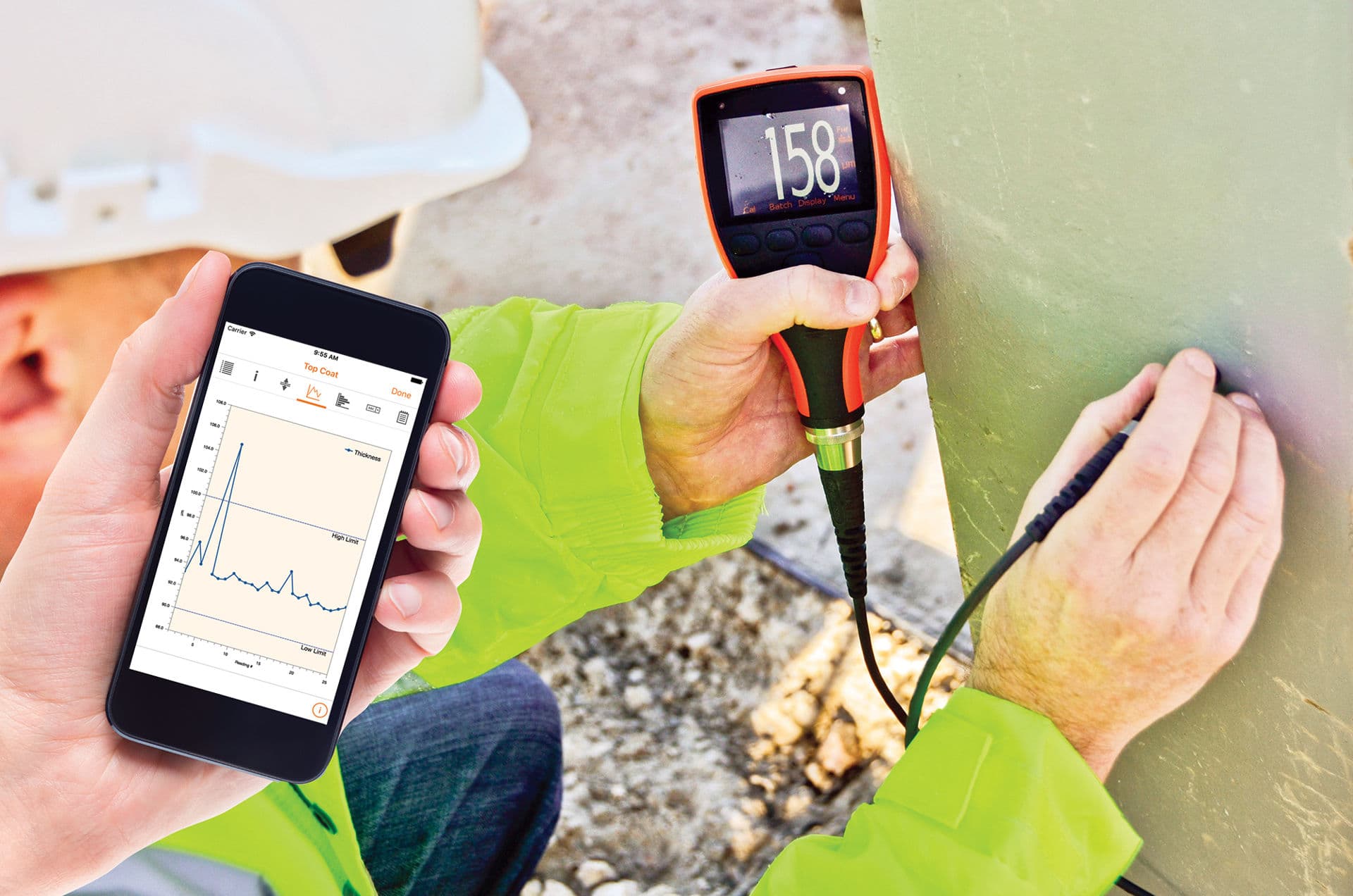 Coating inspection on site, a gauge reading being logged on a phone